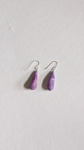 Teardrop shaped handmade ceramic earrings painted in lilac and finished with sterling silver ear wires.