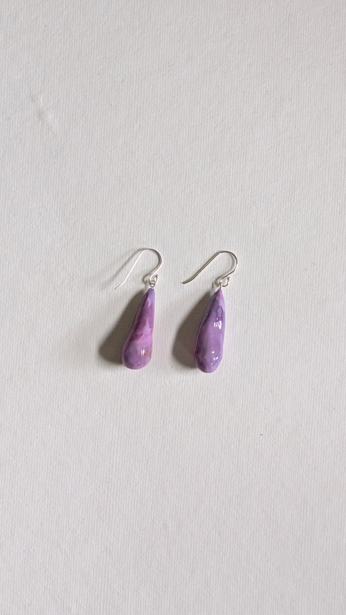 Teardrop shaped handmade ceramic earrings painted in lilac and finished with sterling silver ear wires.
