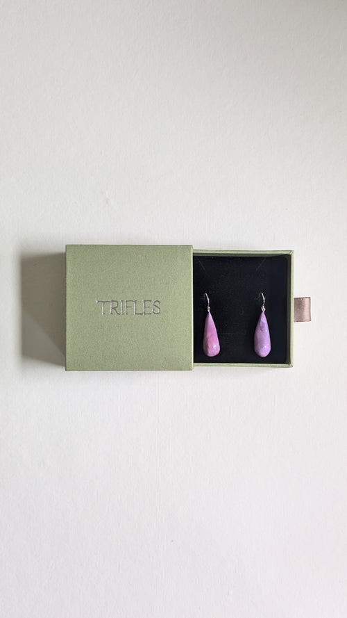 Teardrop shaped handmade ceramic earrings painted in chocolate brown and finished with sterling silver ear wires in Trifles gift box.