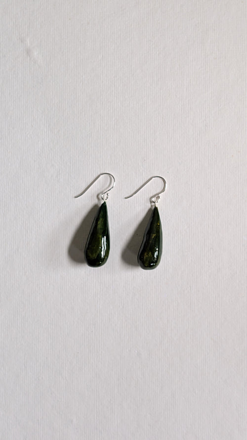 Teardrop shaped handmade ceramic earrings painted in olive green and finished with sterling silver ear wires.