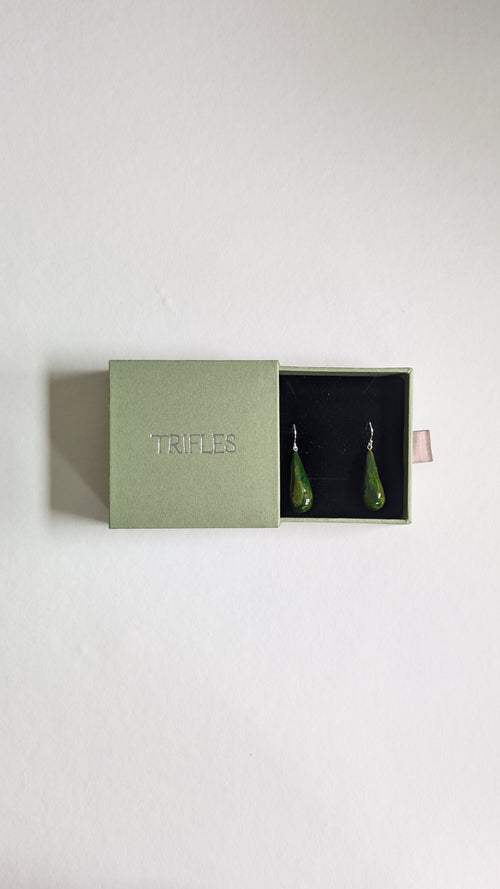 Teardrop shaped handmade ceramic earrings painted in olive green and finished with sterling silver ear wires in Trifles gift box.