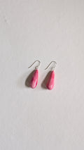 Teardrop shaped handmade ceramic earrings painted in peony pink and finished with sterling silver ear wires.