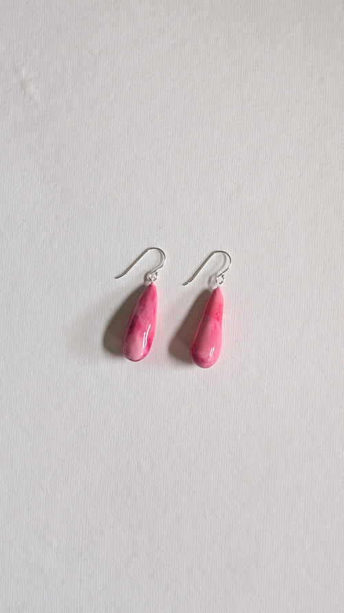 Teardrop shaped handmade ceramic earrings painted in peony pink and finished with sterling silver ear wires.
