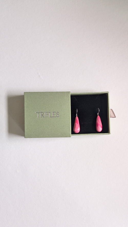 Teardrop shaped handmade ceramic earrings painted in chocolate brown and finished with sterling silver ear wires in Trifles gift box.