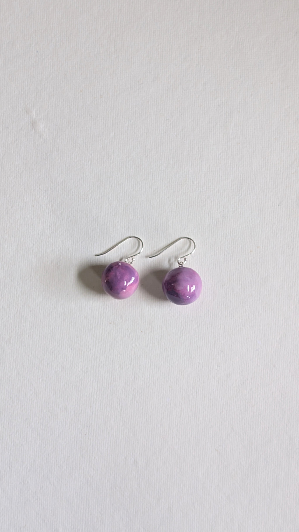 Handmade ceramic orb shaped earrings in lilac with sterling silver ear wires.