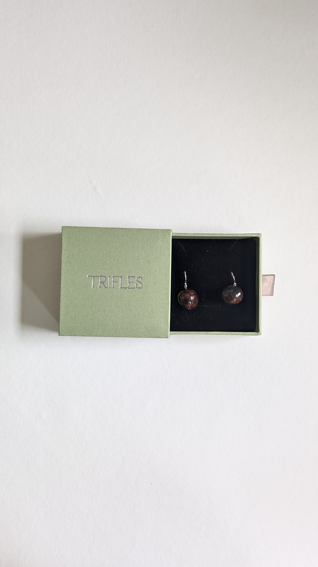 Hand painted ceramic orb earrings in chocolate brown with sterling silver ear wires in Trifles gift box.