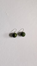 Handmade ceramic orb shaped earrings in olive green with sterling silver ear wires.