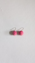 Orb shaped handmade ceramic earrings painted in peony pink and finished with sterling silver ear wires.