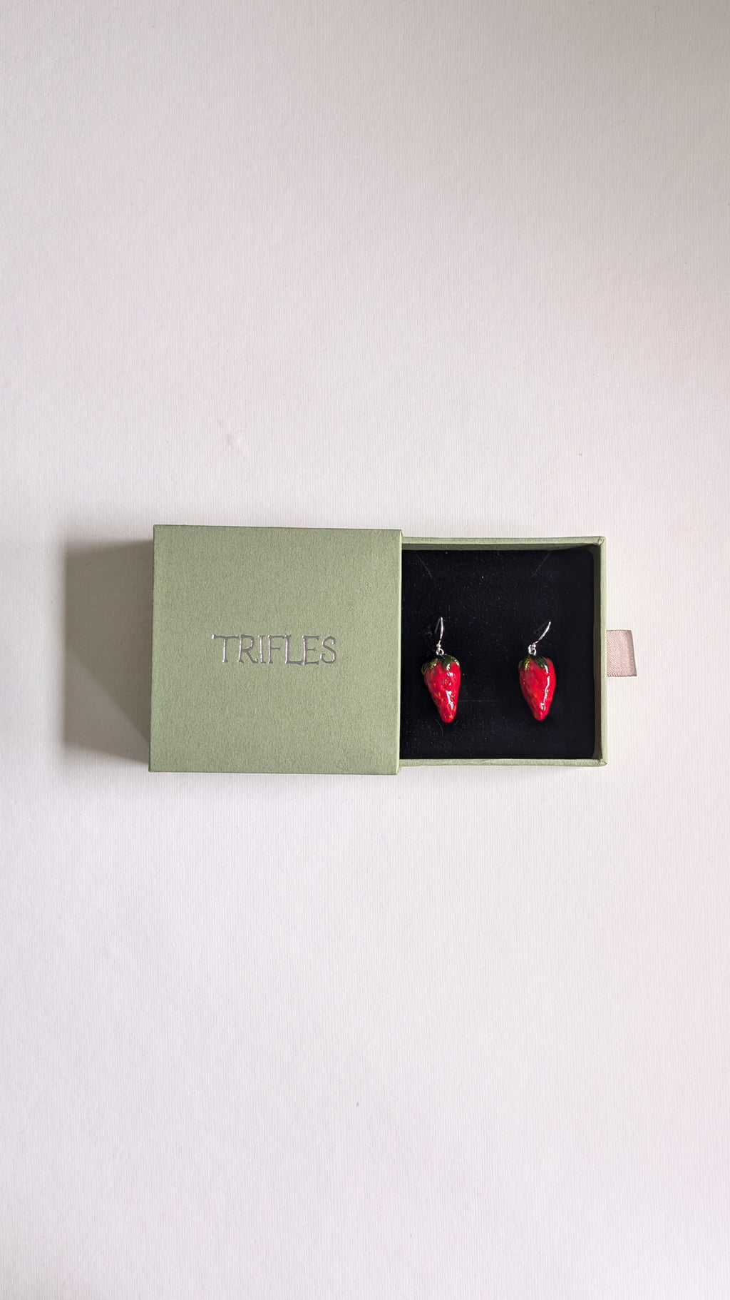 Hand painted ceramic strawberry earrings with sterling silver ear wires in Trifles gift box.